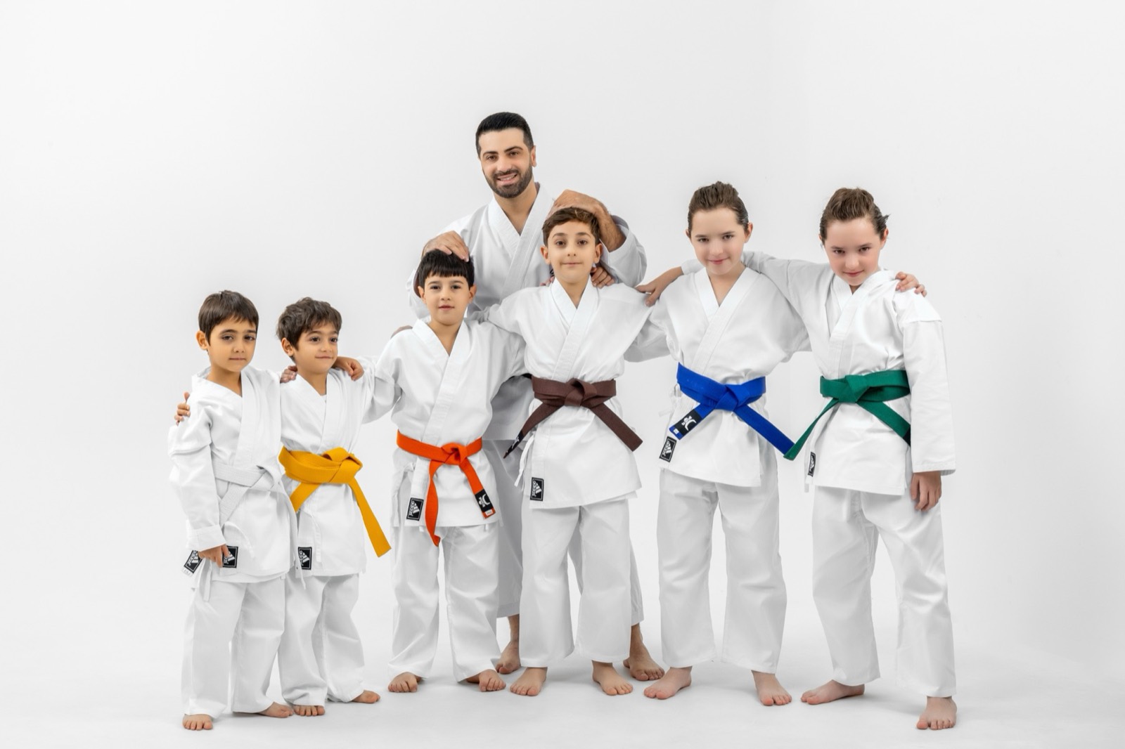 Coach Zhirayr Petrosyan with students wearing different belt colours