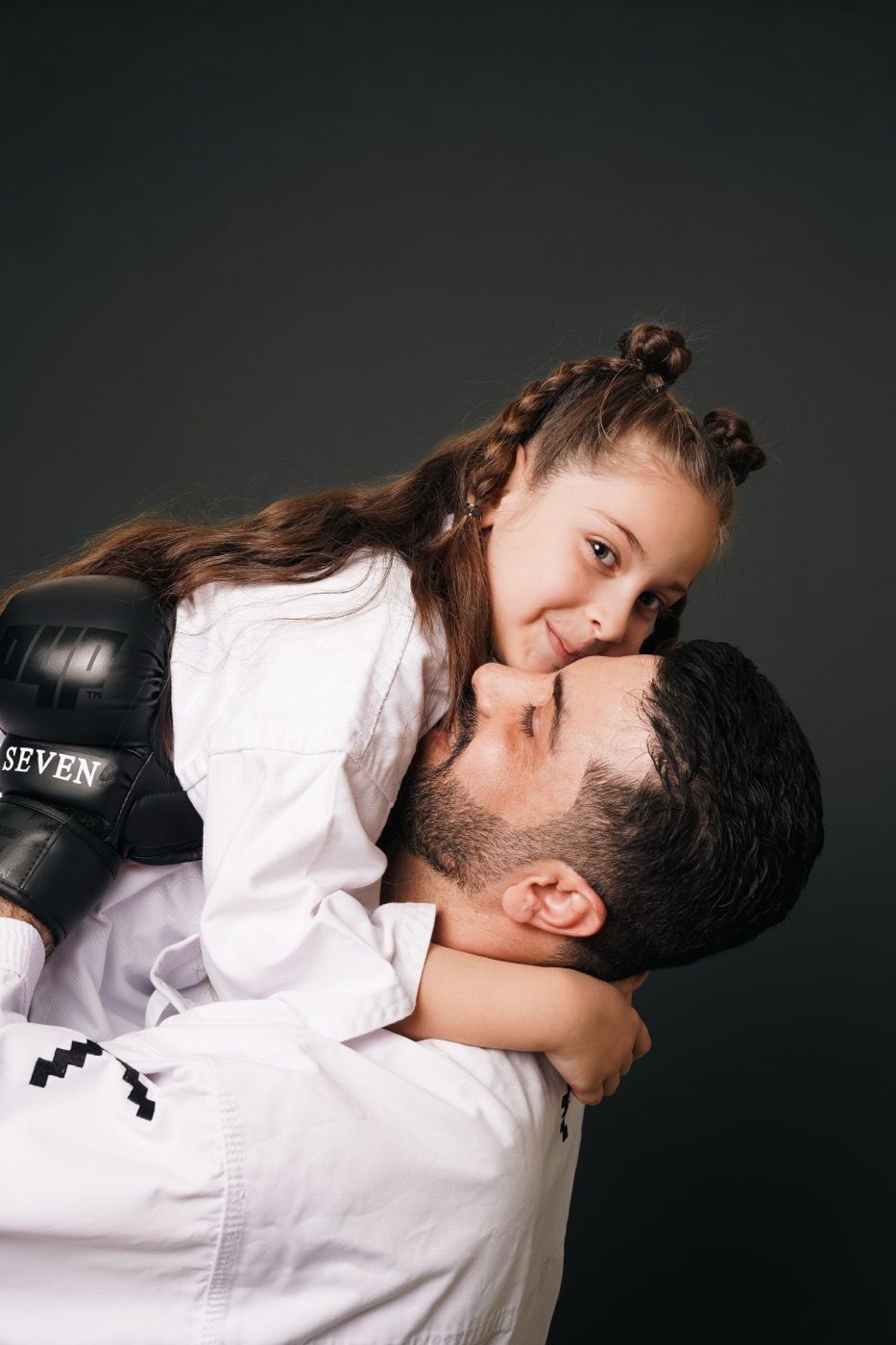 Coach hugging a young student