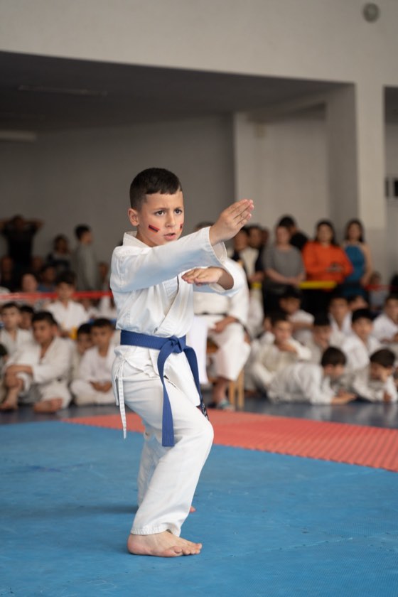 Student performing a block at a tournament