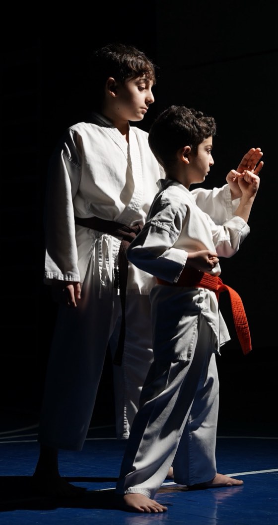 Karateka in gi with their belts