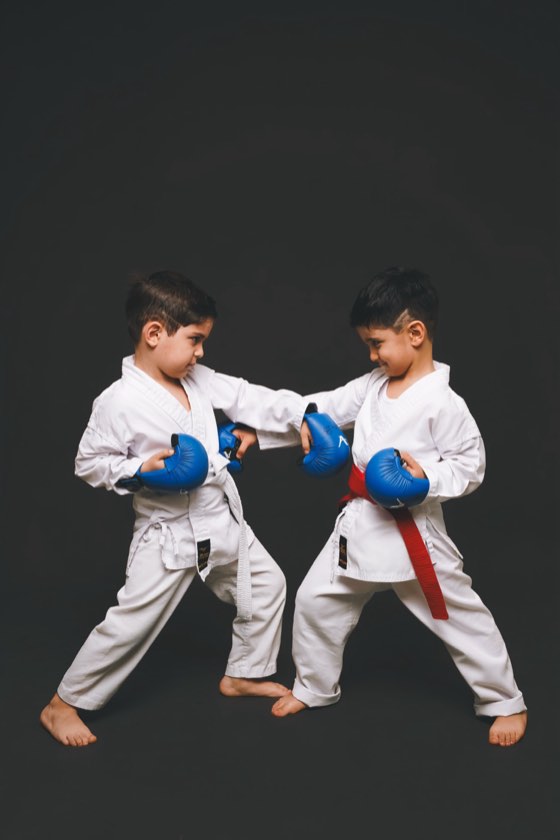 Two boys sparring in gloves