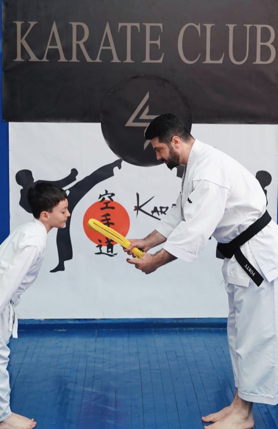 Coach teaching a young student