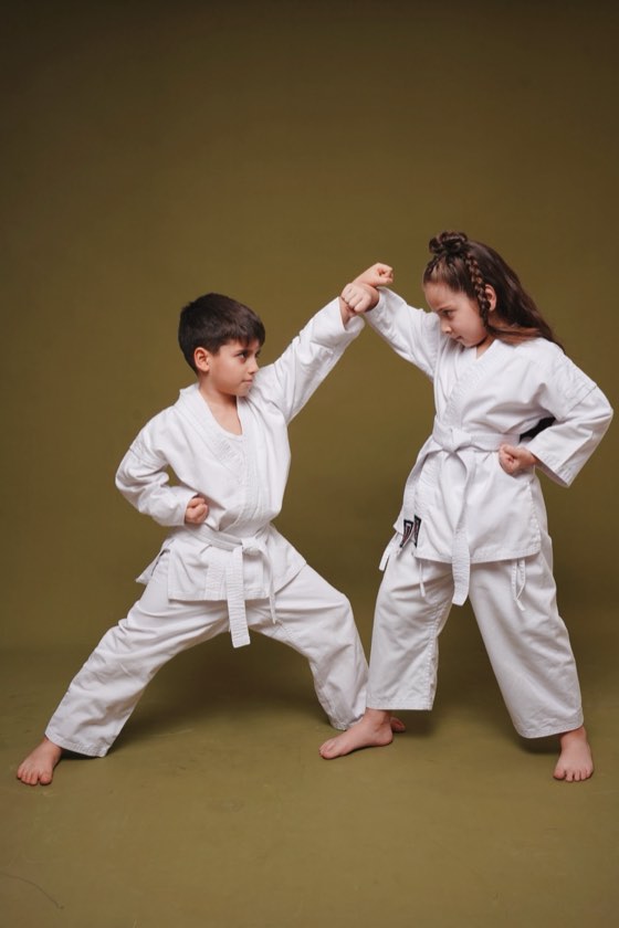 Little students practising block and strike