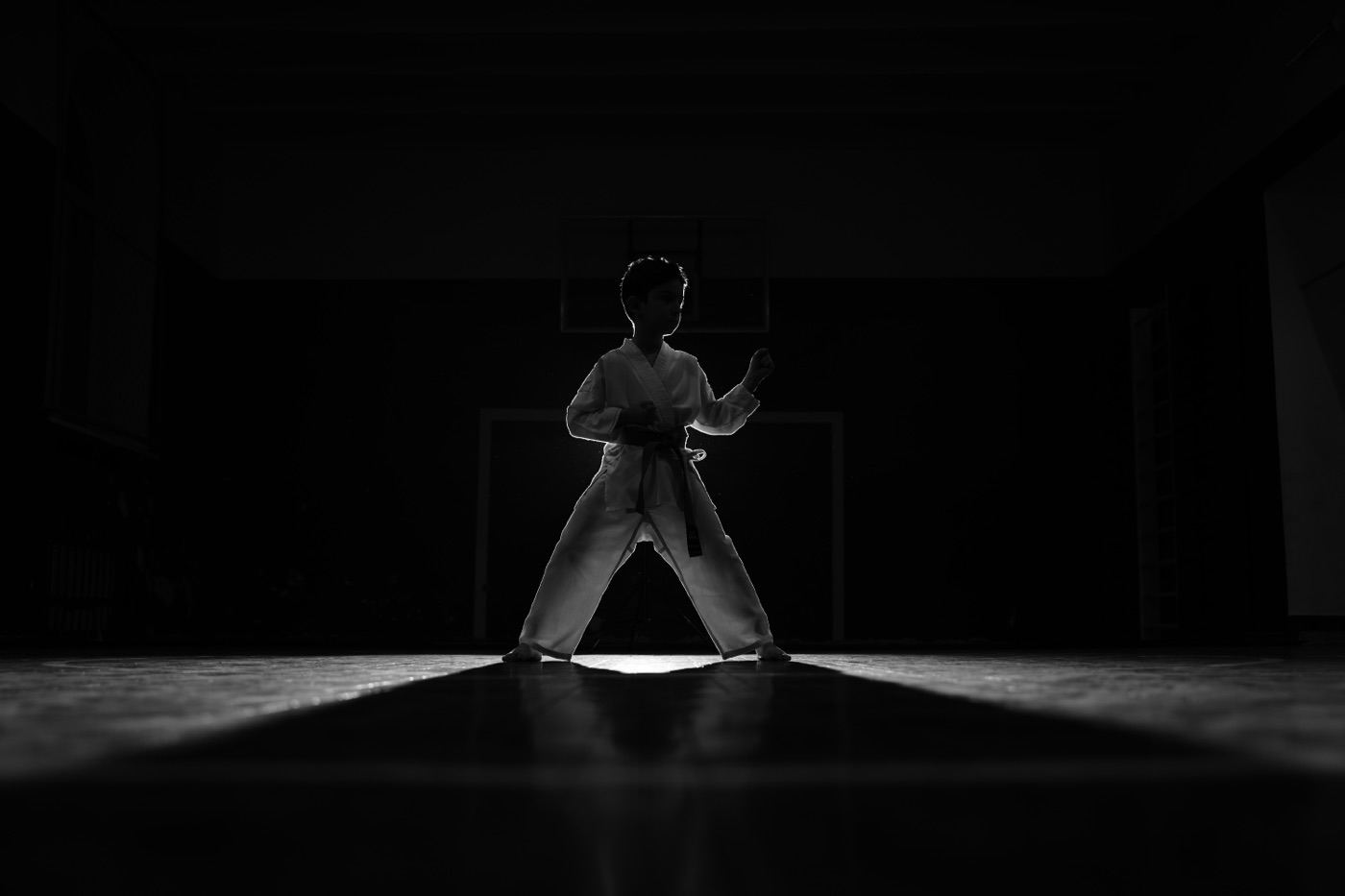 Student in stance in a dark hall