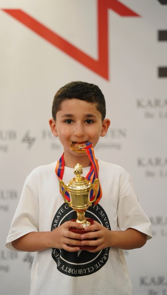 Student with a cup and medal