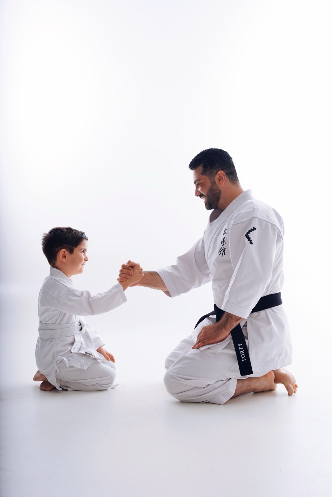 Coach greeting a student with a handshake
